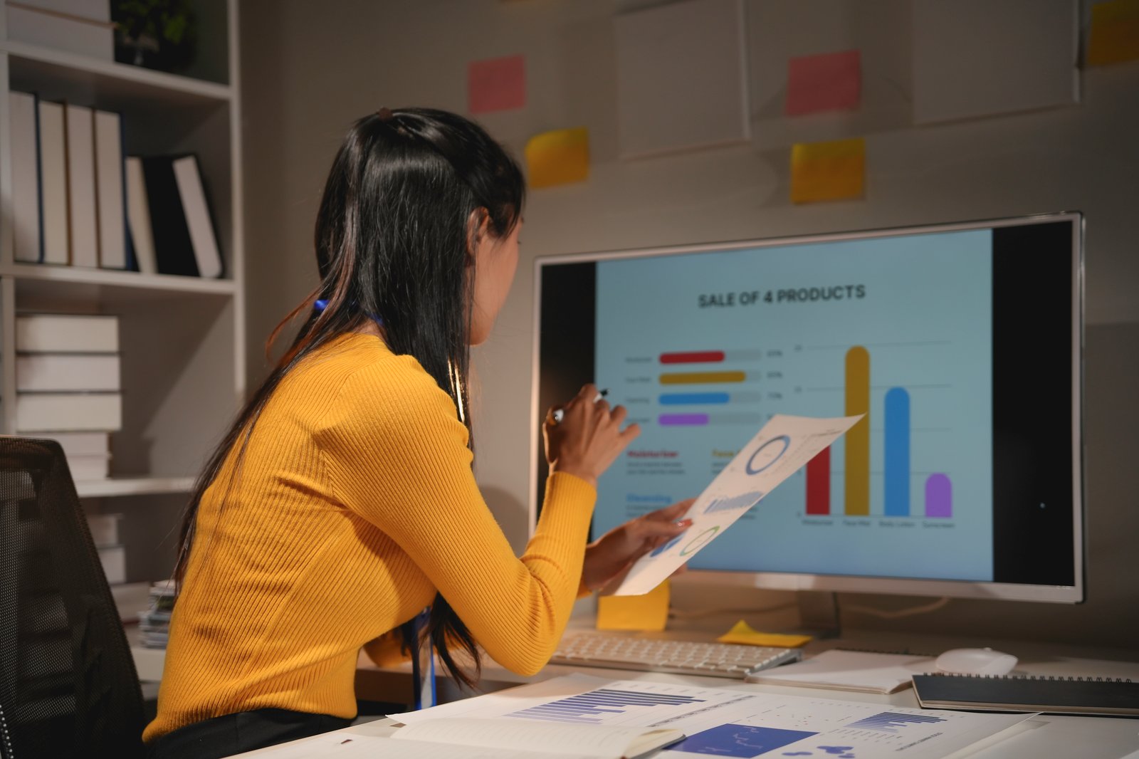 Analyst reviewing sales dashboards in an office
