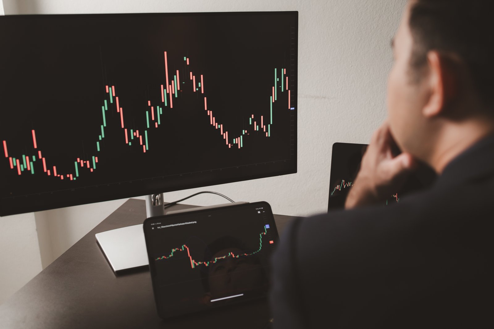 Financial analyst reviewing market trends on screen