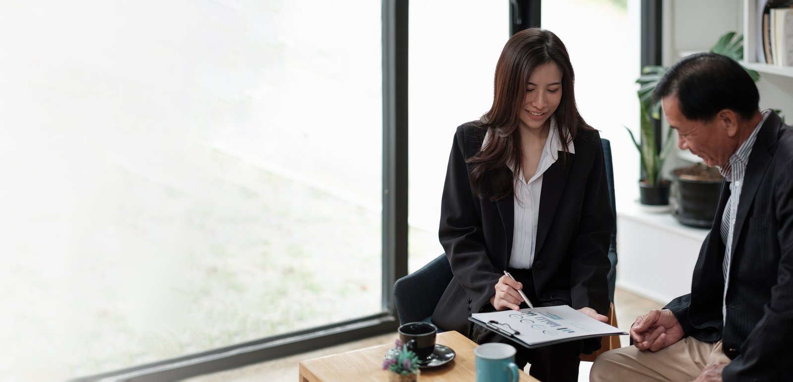 Adviser explaining charts to a client in a meeting