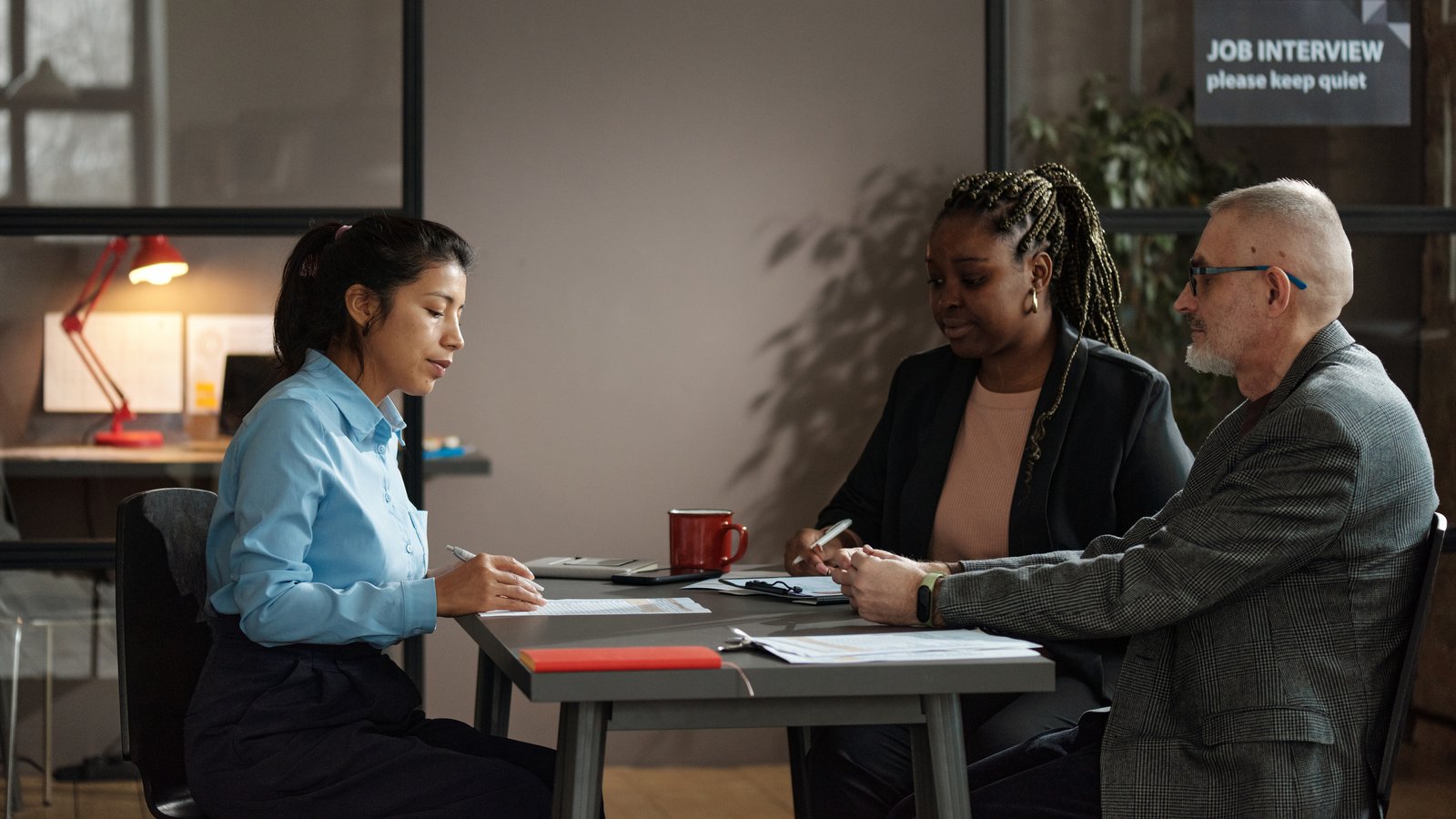 Colleagues discussing work at a conference table